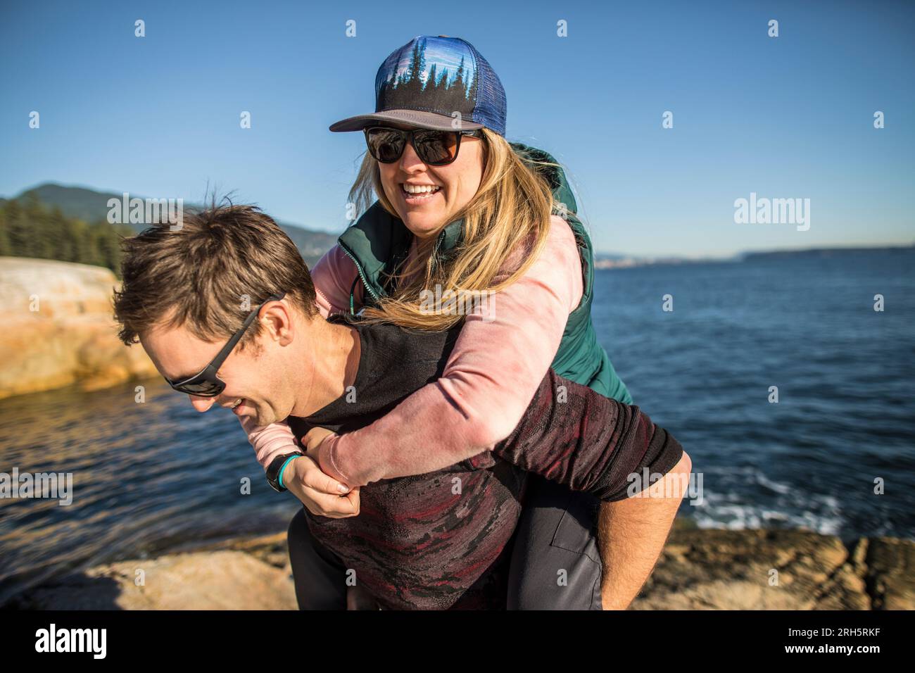 fun lively couple having a good laugh together at the beach Stock Photo