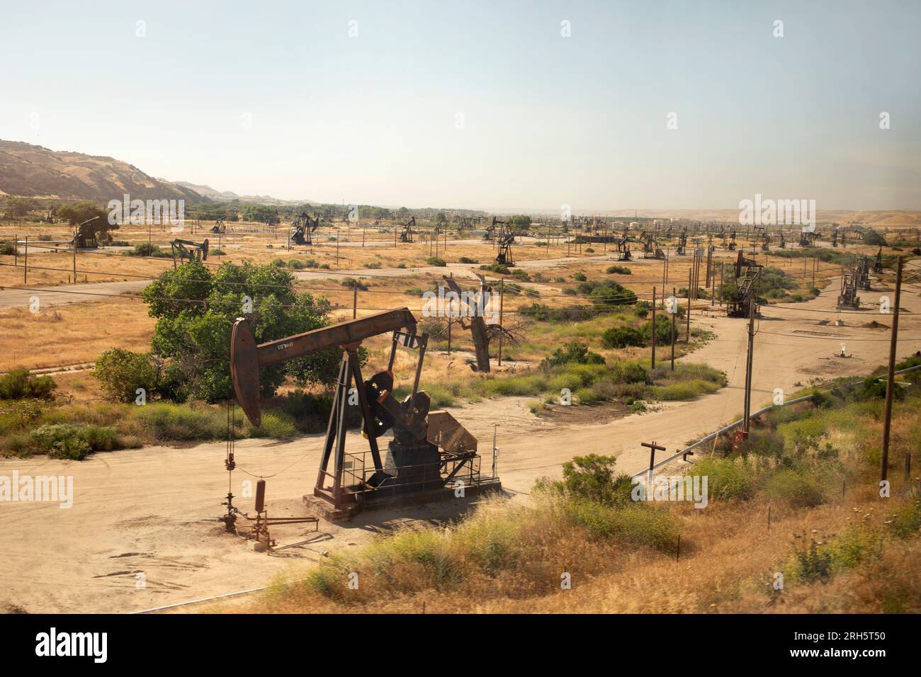 Field of oil rigs visible from passenger train Stock Photo - Alamy