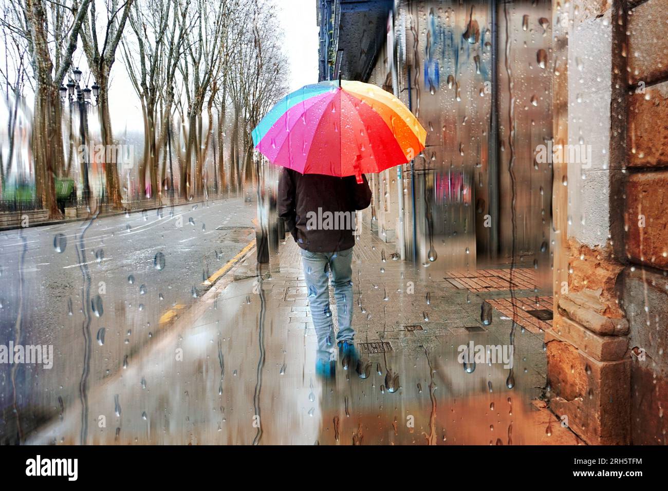pedestrian with an umbrella in rainy days in winter season Stock Photo ...
