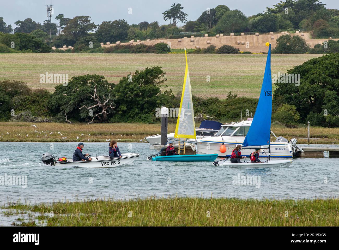 young children learning to sail small dinghies under the supervision of
