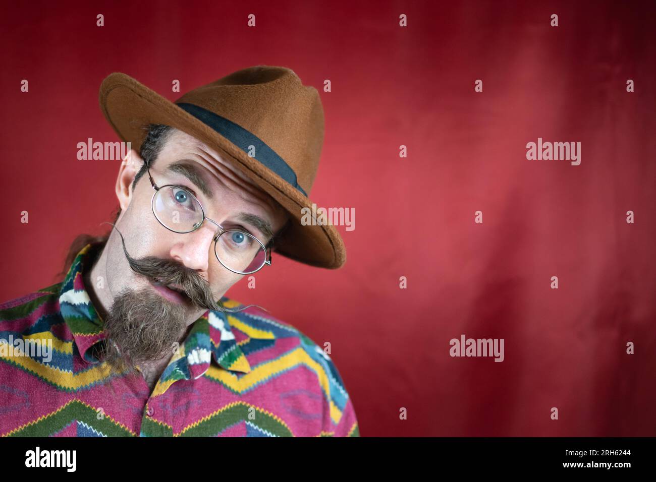 Vintage Hipster man with mustache, glasses, brown hat and asking ...