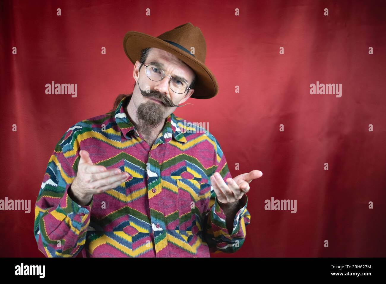 Vintage Hipster man with interrogative expression to camera and asking