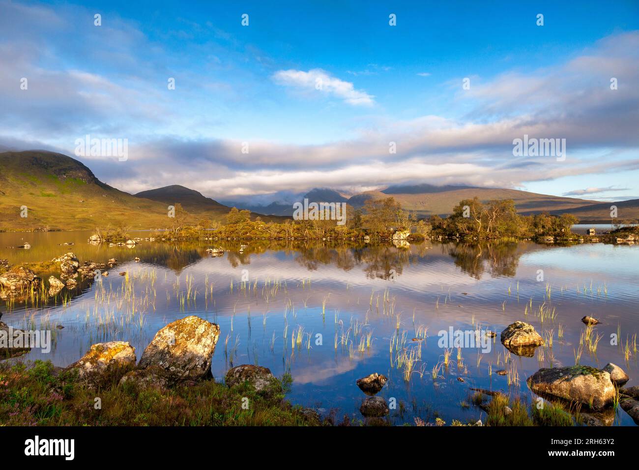 Loch na h-Achlaise, Rannoch Moor, Scotland, on a beautiful early autumn evening. Leaves are turning but are still on trees. Stock Photo
