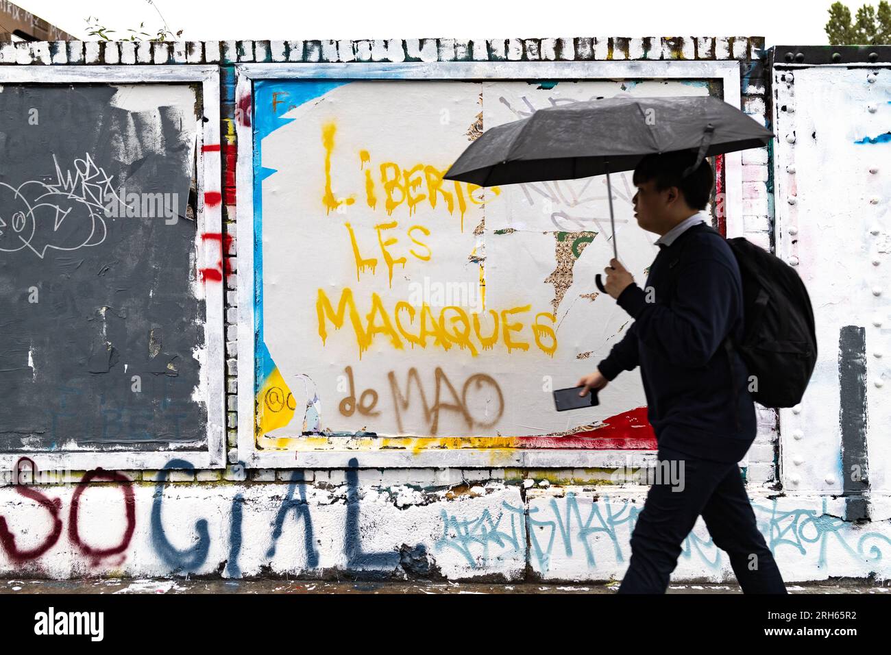 a-man-walks-past-an-anti-beijing-counter-slogans-liberty-the-monkey-of