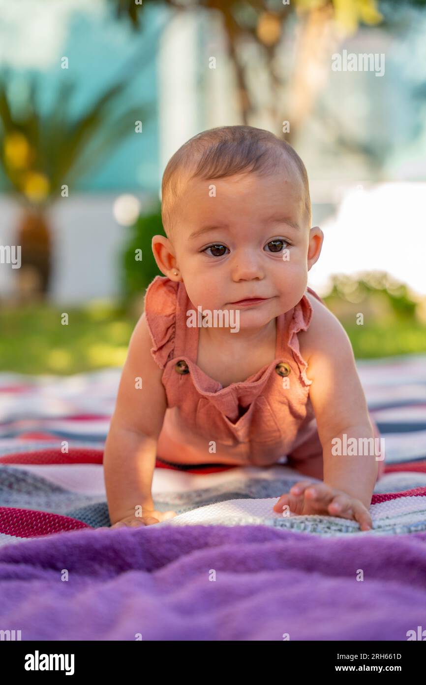 little smiling baby learning to cra…