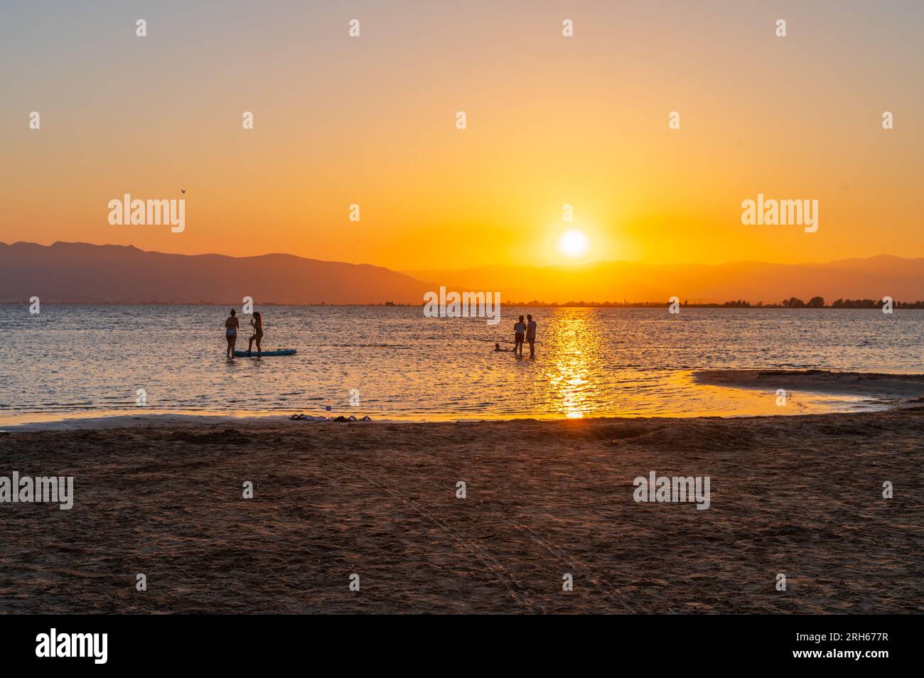 People enjoying sunset at Trabucador beach, Ebro Delta, Tarragona, Spain Stock Photo