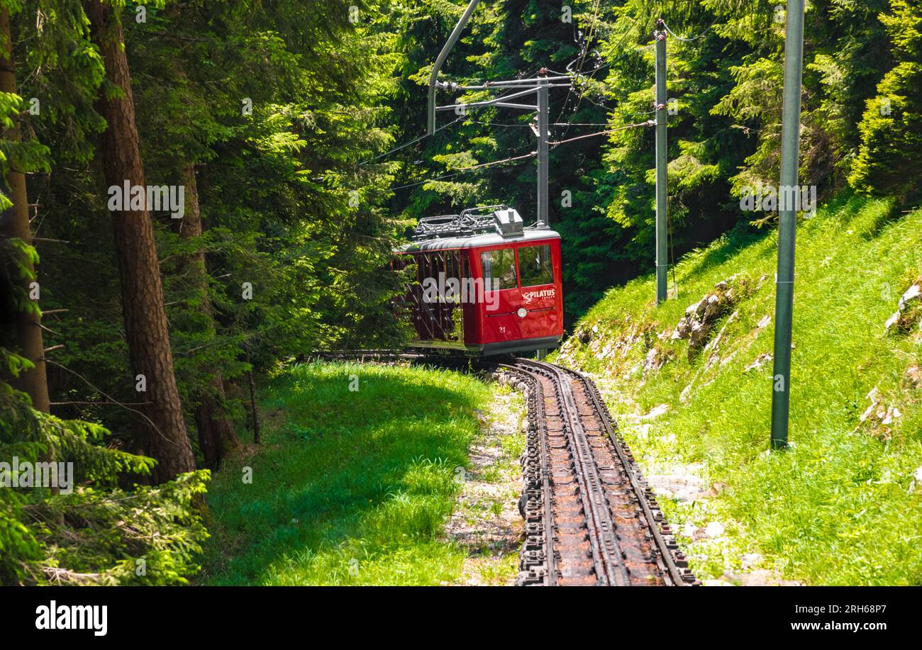 Great close-up view of an approaching red coloured cogwheel train. It is the Pilatus Railway, a mountain railway in Switzerland and the steepest rack... Stock Photo