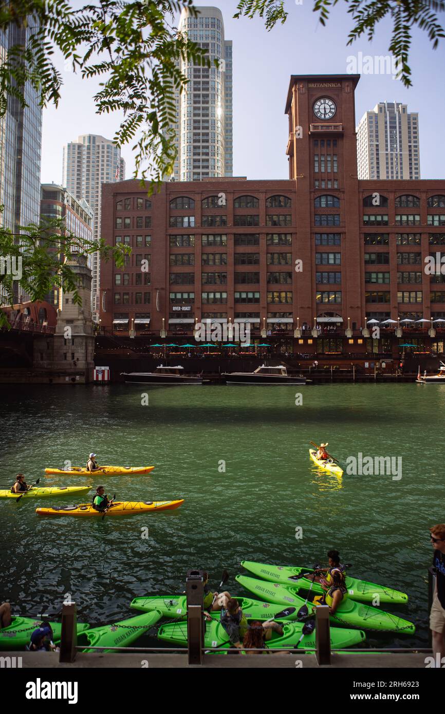 A group of tourists in kayaks in Chicago River with Reid Murdoch Building behind, Chicago