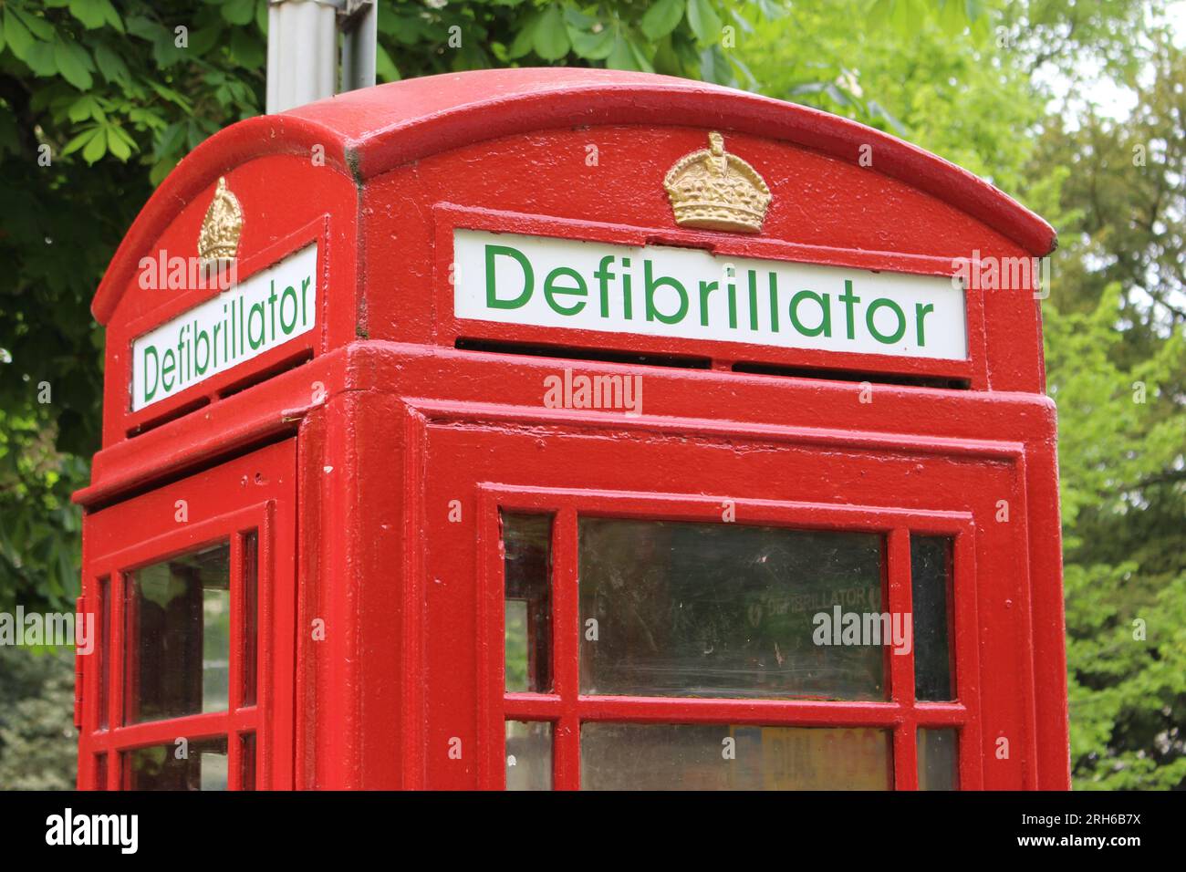 Old Red telephone box converted to hold defibrillator. Typical British telephone booth reimagined as defibrillator station (Cheltenham, England) Stock Photo
