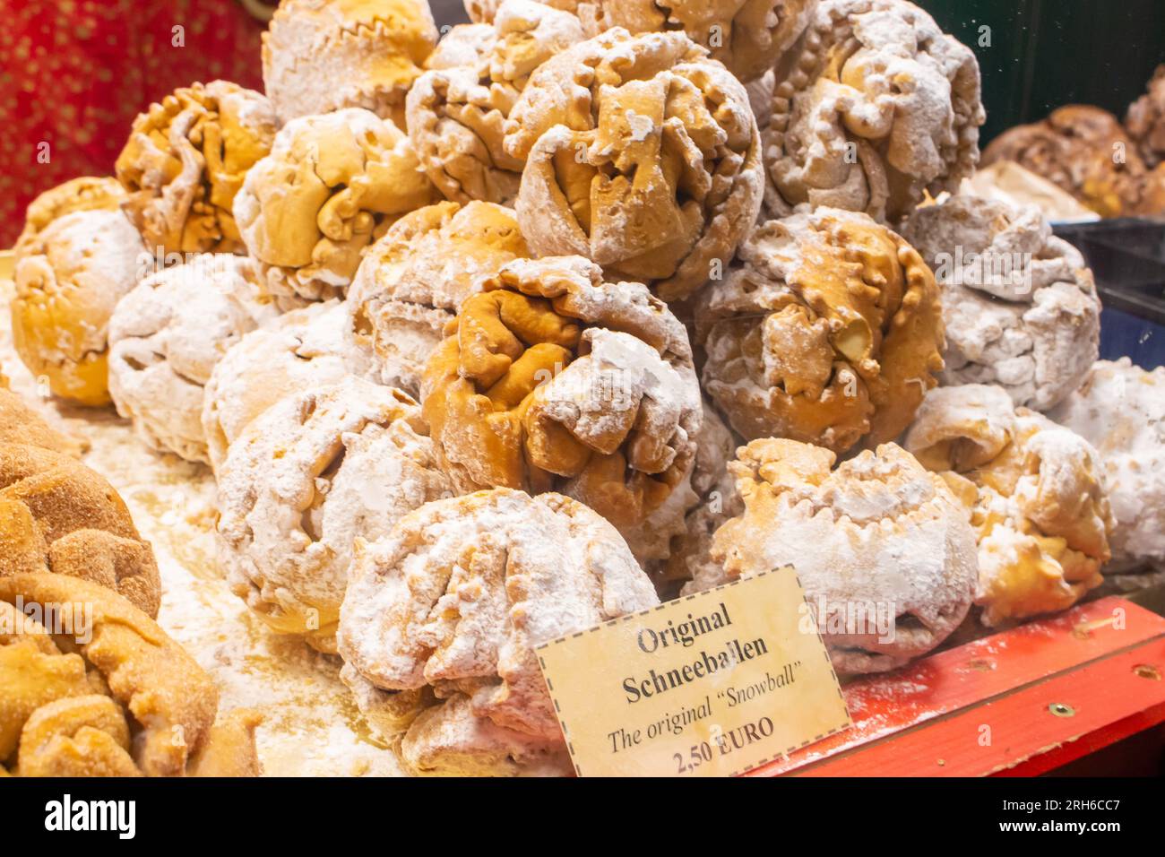 Fresh snowball cookies with price tag. Tasty cookies balls on outdoor market. Traditional bavarian dessert. Shortbread balls. Street food. Stock Photo