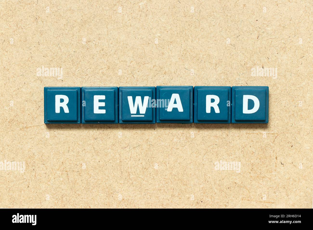Tile alphabet letter in word reward on wood background Stock Photo
