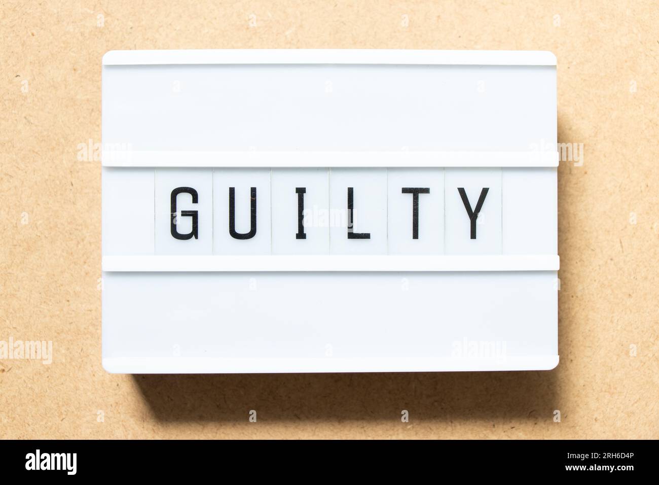 Lightbox with word guilty on wood background Stock Photo