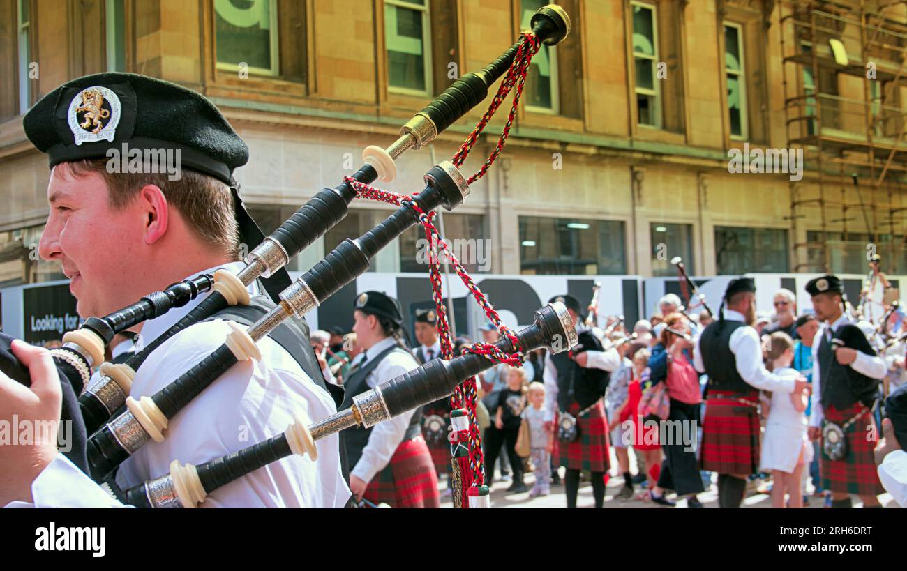 Glasgow, Scotland, UK. 14th  August, 2023.   Piping live hit the city as hundreds of pipe bad musicians swarmed the city centre with the Auckland pipe band from new zealand performing to crowds on buchanan street on the citys style mile.  Credit Gerard Ferry/Alamy Live News Stock Photo