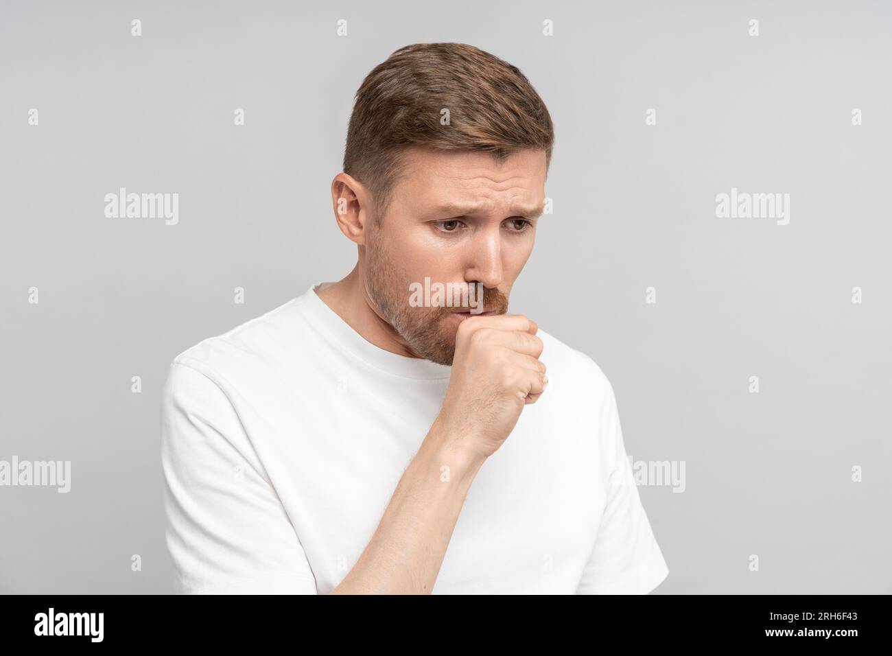 Man coughs, covering himself with fist. Dry cough, phlegm, sore throat