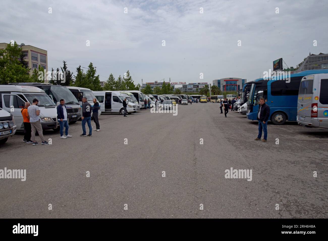 People walking to buses at the North South bus terminal, one of 3 bus stations in Tirana, capital city of Albania Stock Photo