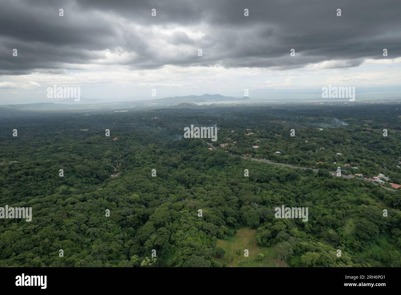 Green valley landscape with lake and volcano and road to Managua in latin America aerial drone view Stock Photo