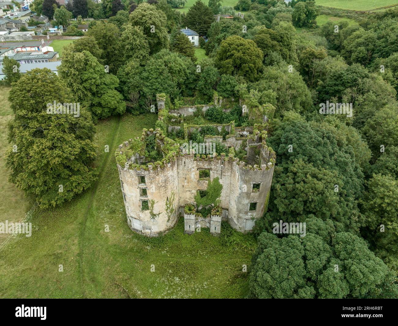 Aerial view of ruined and overgrown Buttevant or Barry's castle on the Awbeg river in County Cork Ireland with large circular towers Stock Photo