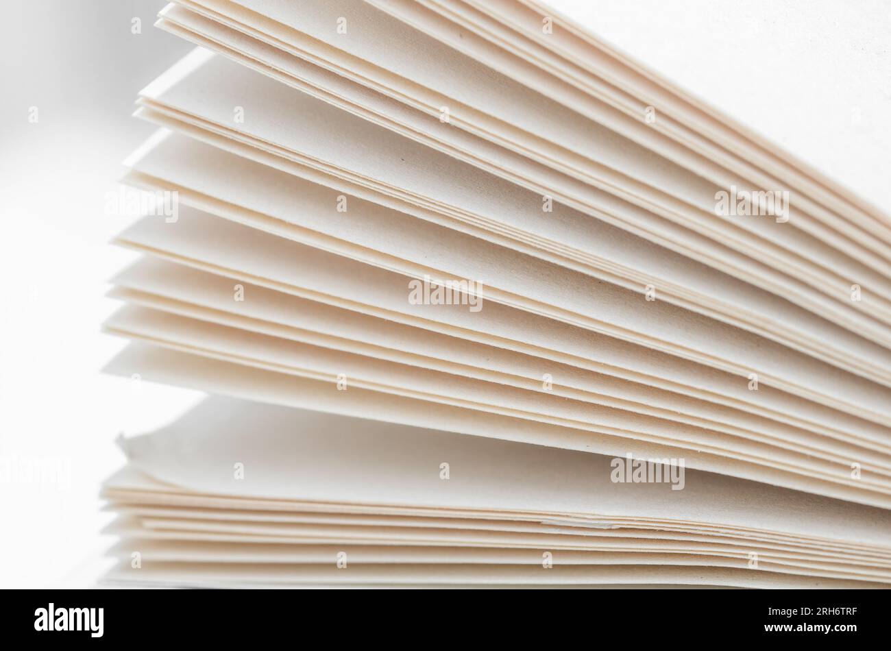 Bending stack of paper sheets, open magazine with copy space Stock Photo