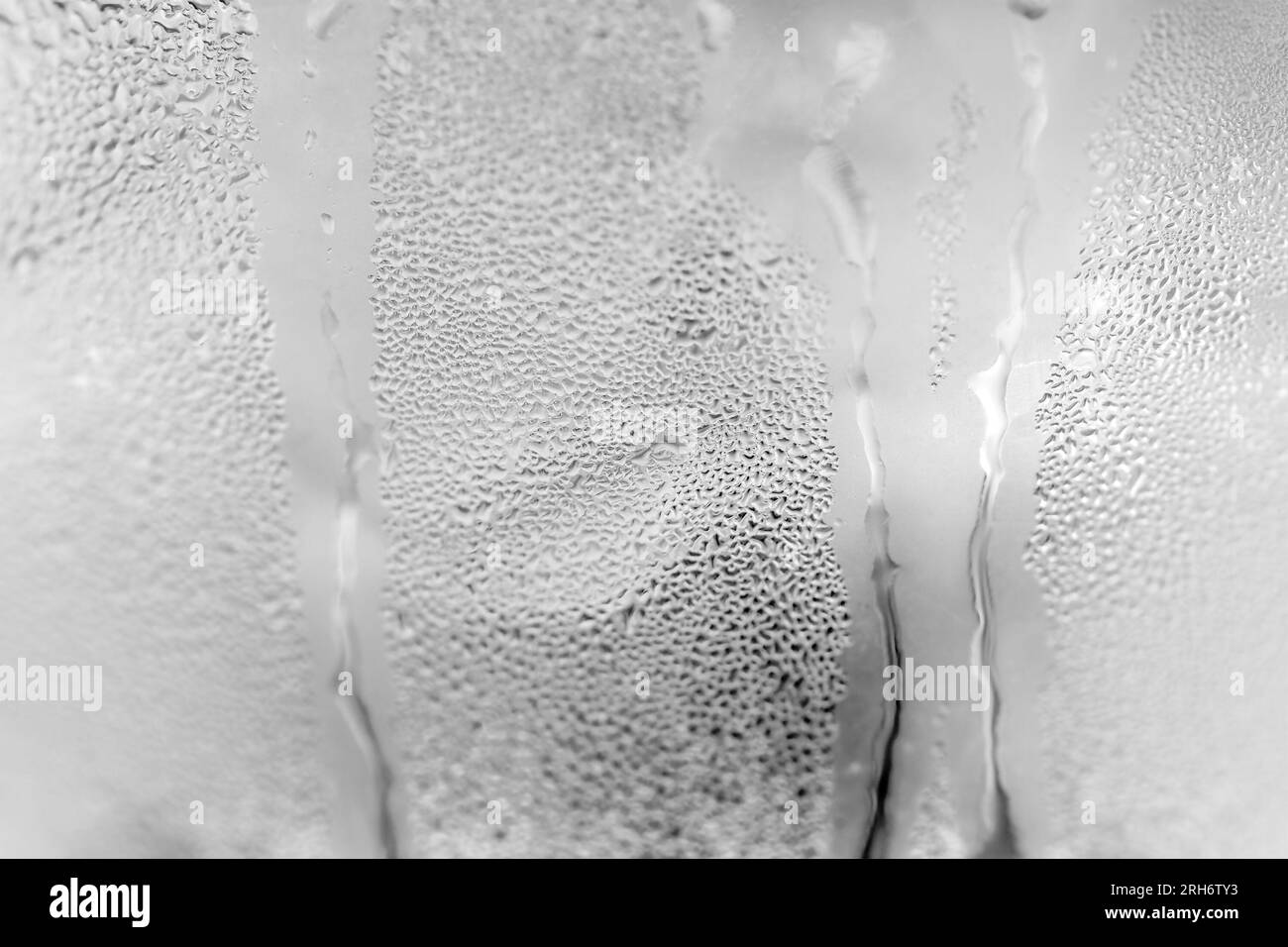 Ice cold glass, covered with water drops. Close-up Stock Photo