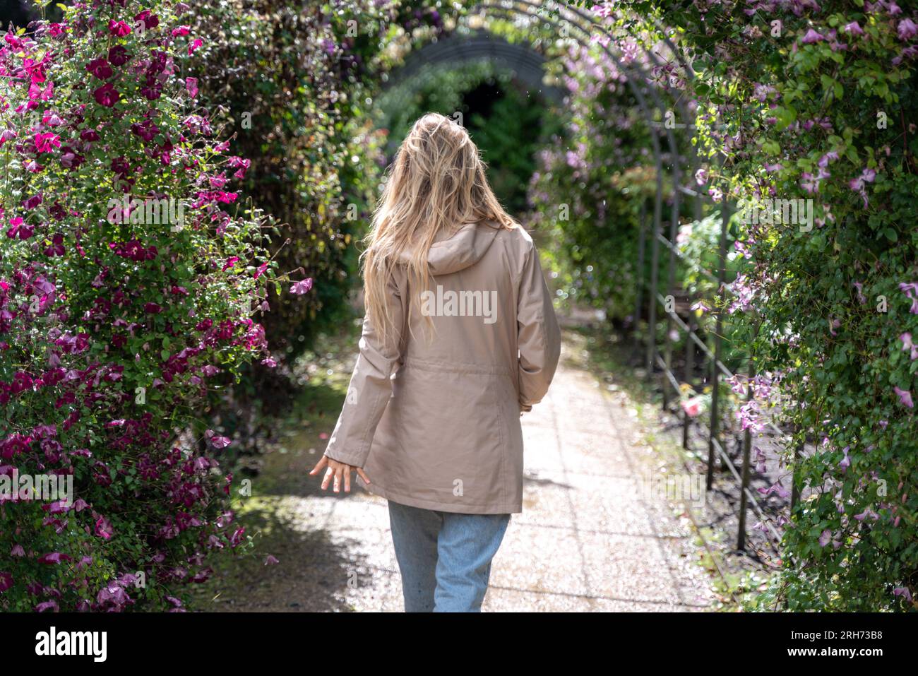 young woman taking a walk through gardens Stock Photo - Alamy