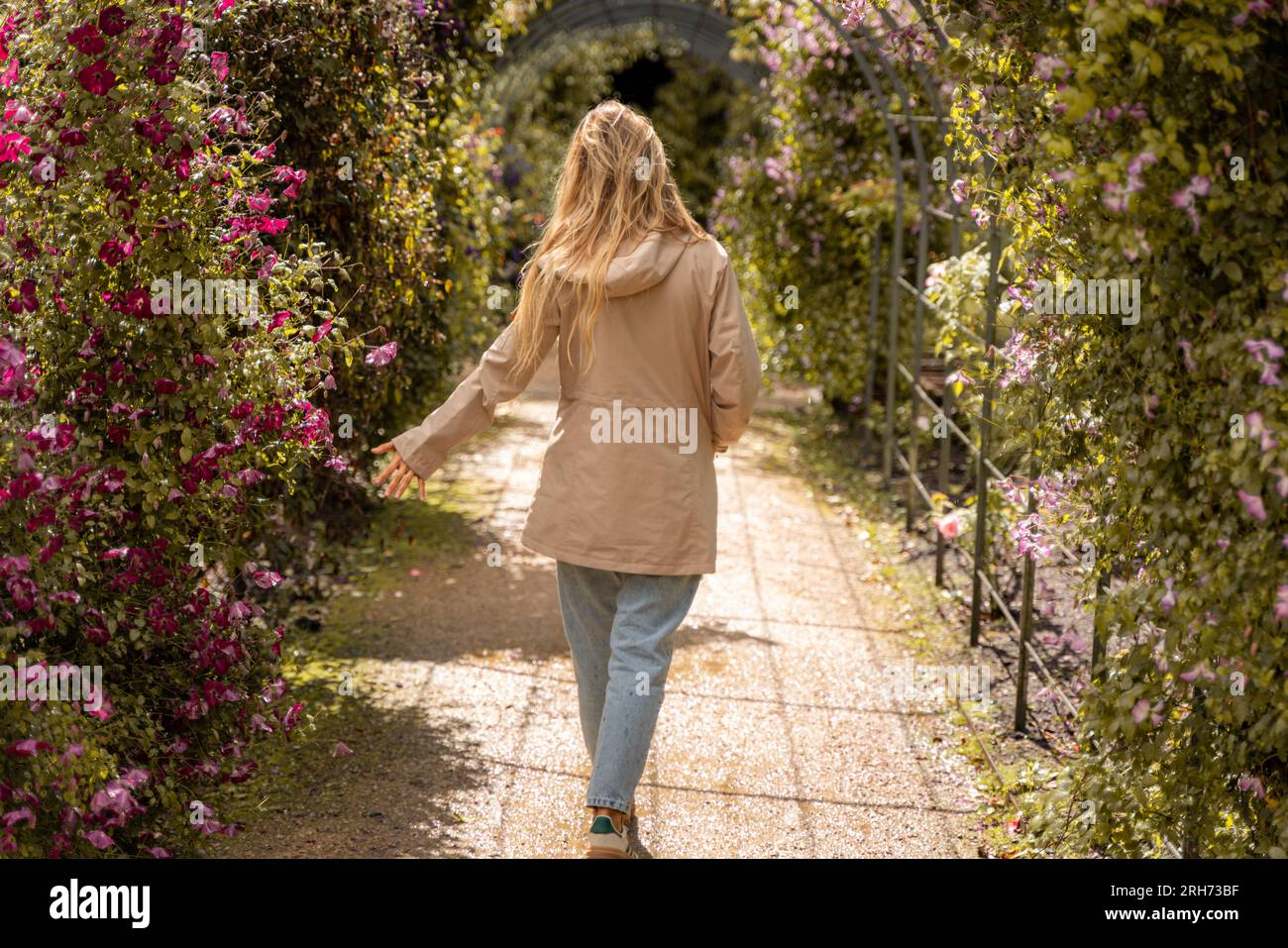 young woman taking a walk through gardens Stock Photo - Alamy