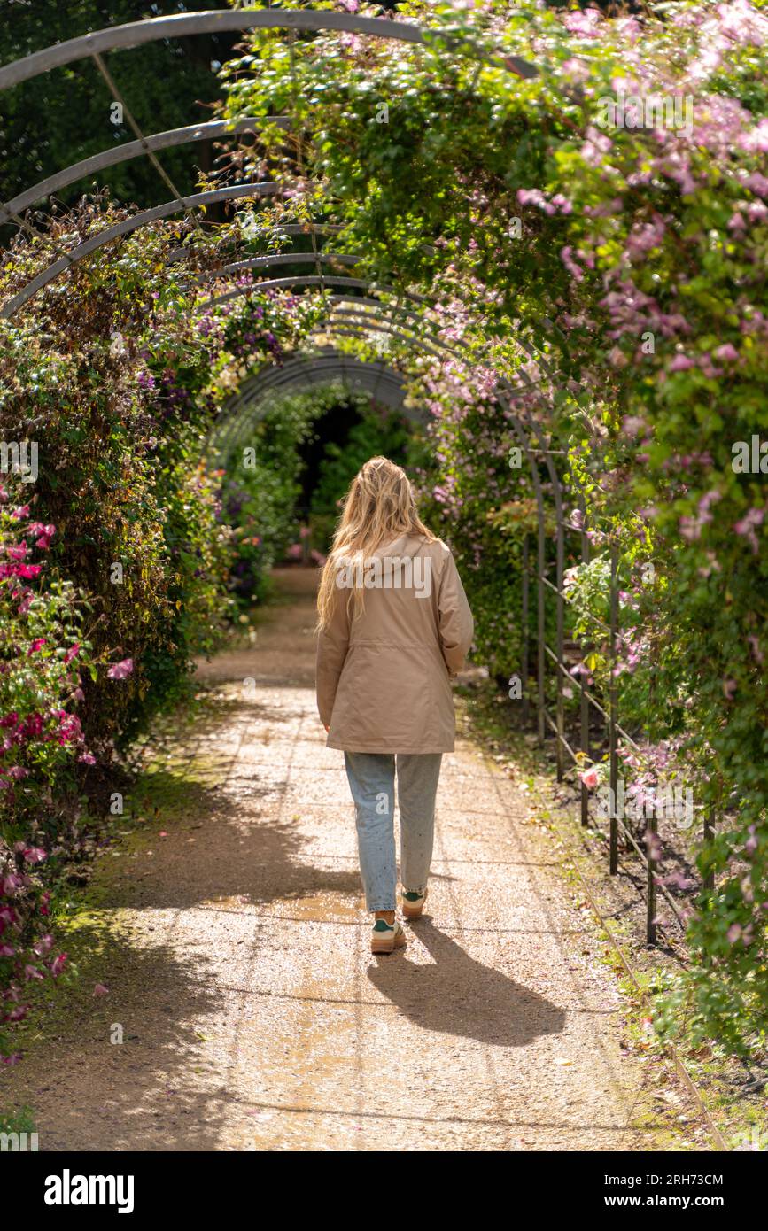 young woman taking a walk through gardens Stock Photo - Alamy