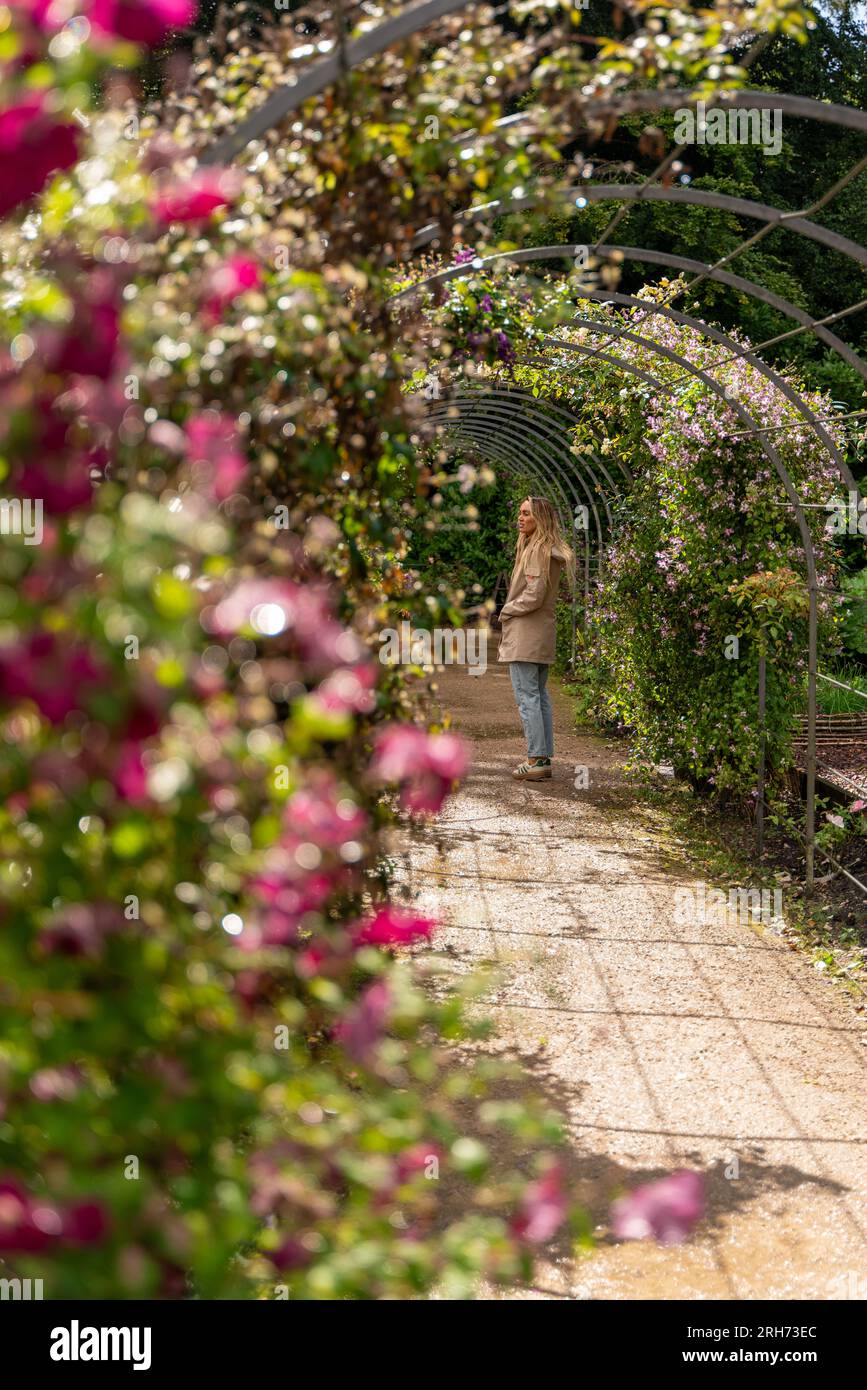 young woman taking a walk through gardens Stock Photo - Alamy