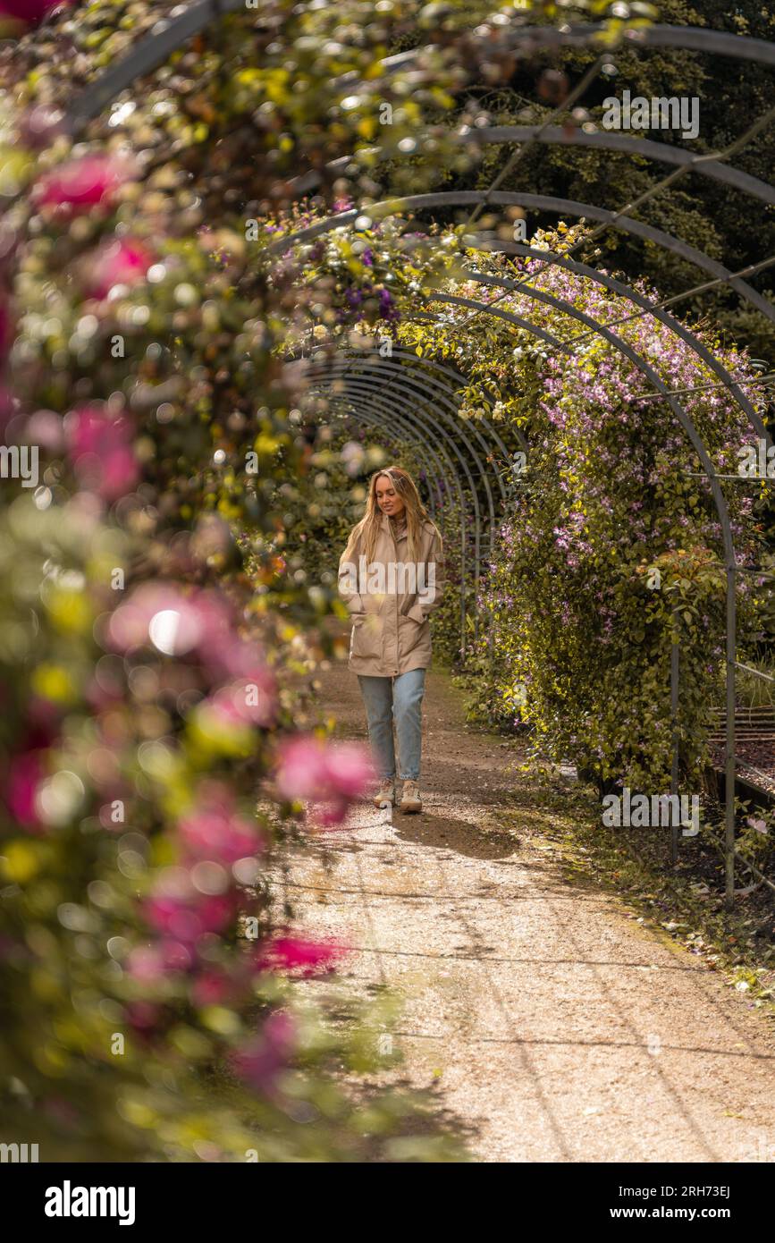 young woman taking a walk through gardens Stock Photo - Alamy
