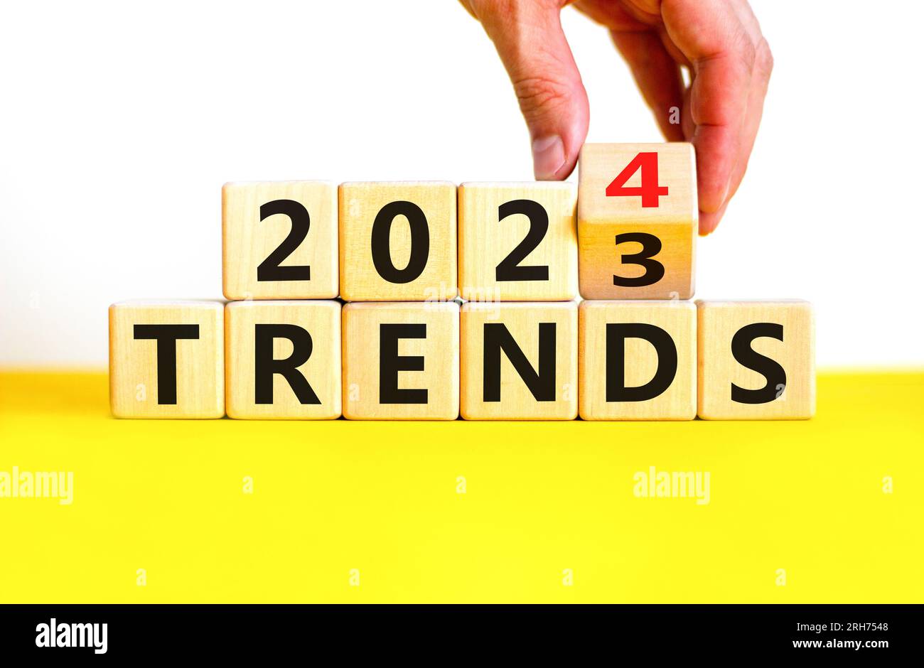 2025 trends new year symbol. Businessman turns a wooden cube and