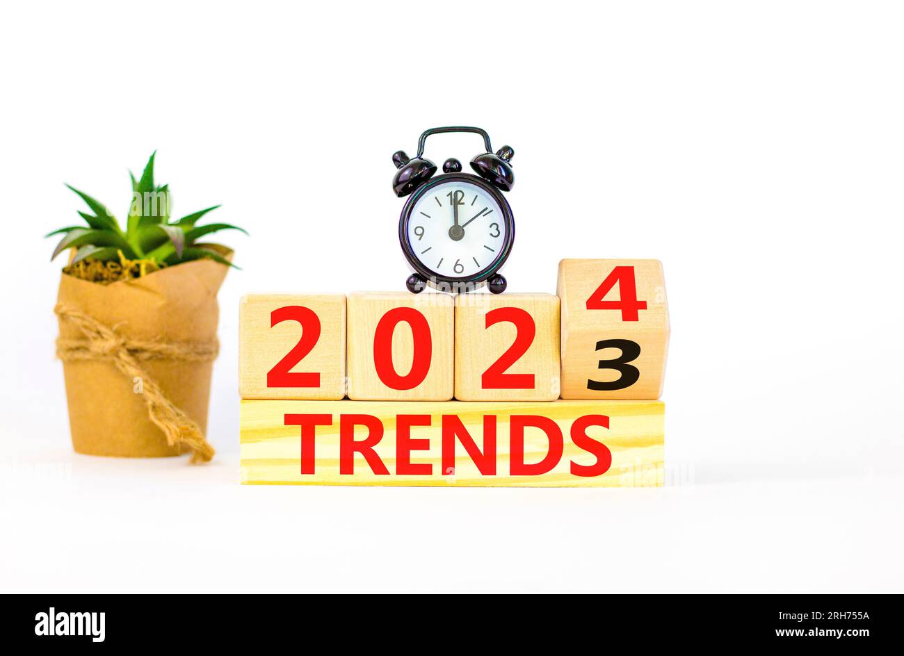 2024 trends new year symbol. Businessman turns a wooden cube and