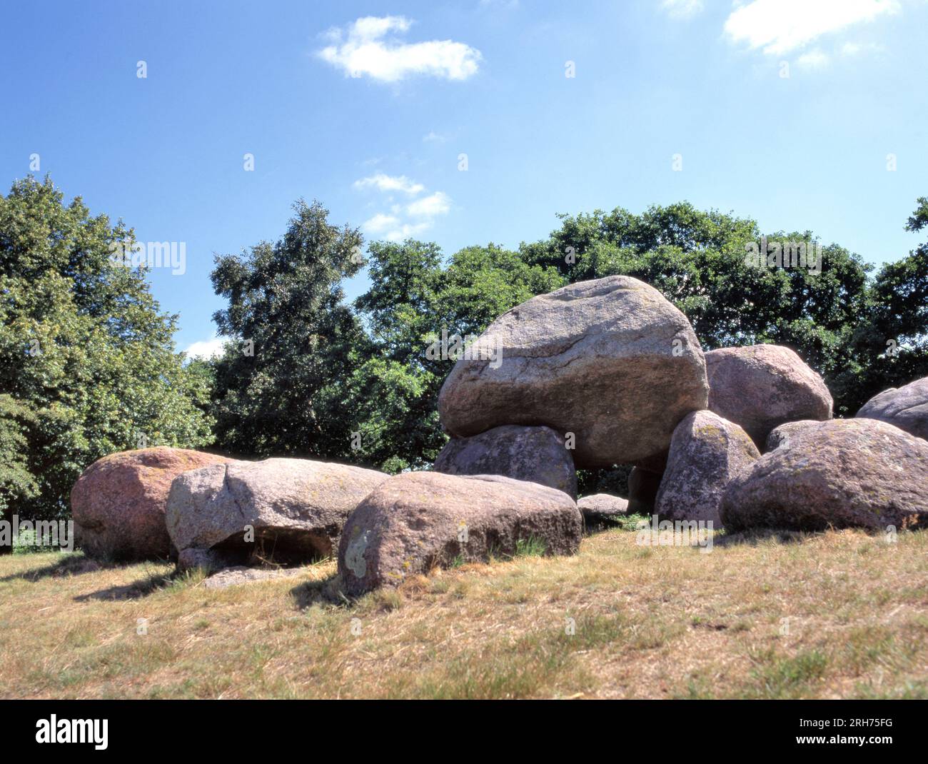 A dolmen or Hunebed in Dutch is a type of single-chamber megalithic tomb, usually consisting of two or more vertical megaliths supporting a large flat Stock Photo