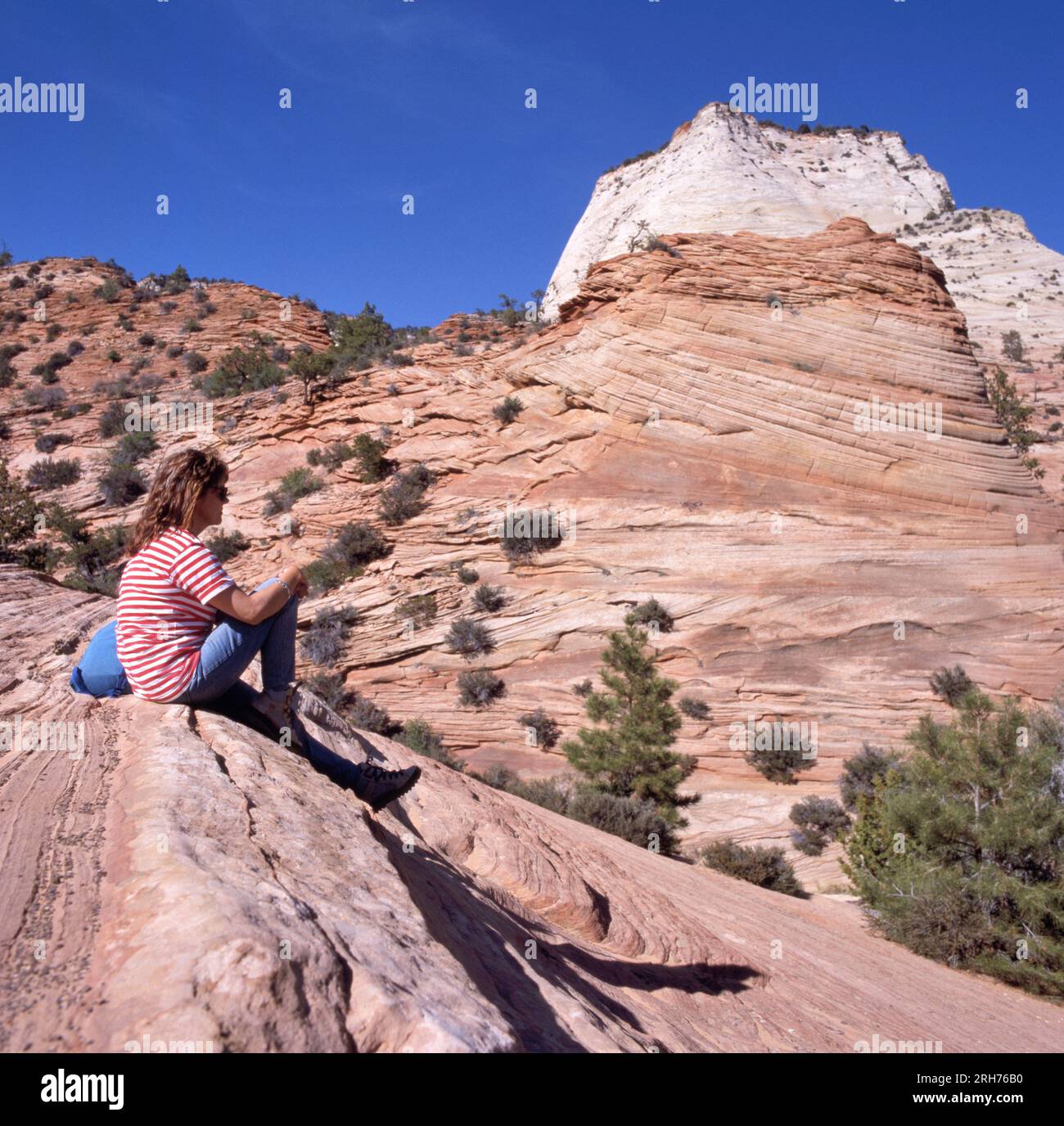 ZION NATIONAL PARK, USA - MAY 11, 2022: Girl enjoying the beautiful view in Zion National Park, Utah with clear blue sky Stock Photo