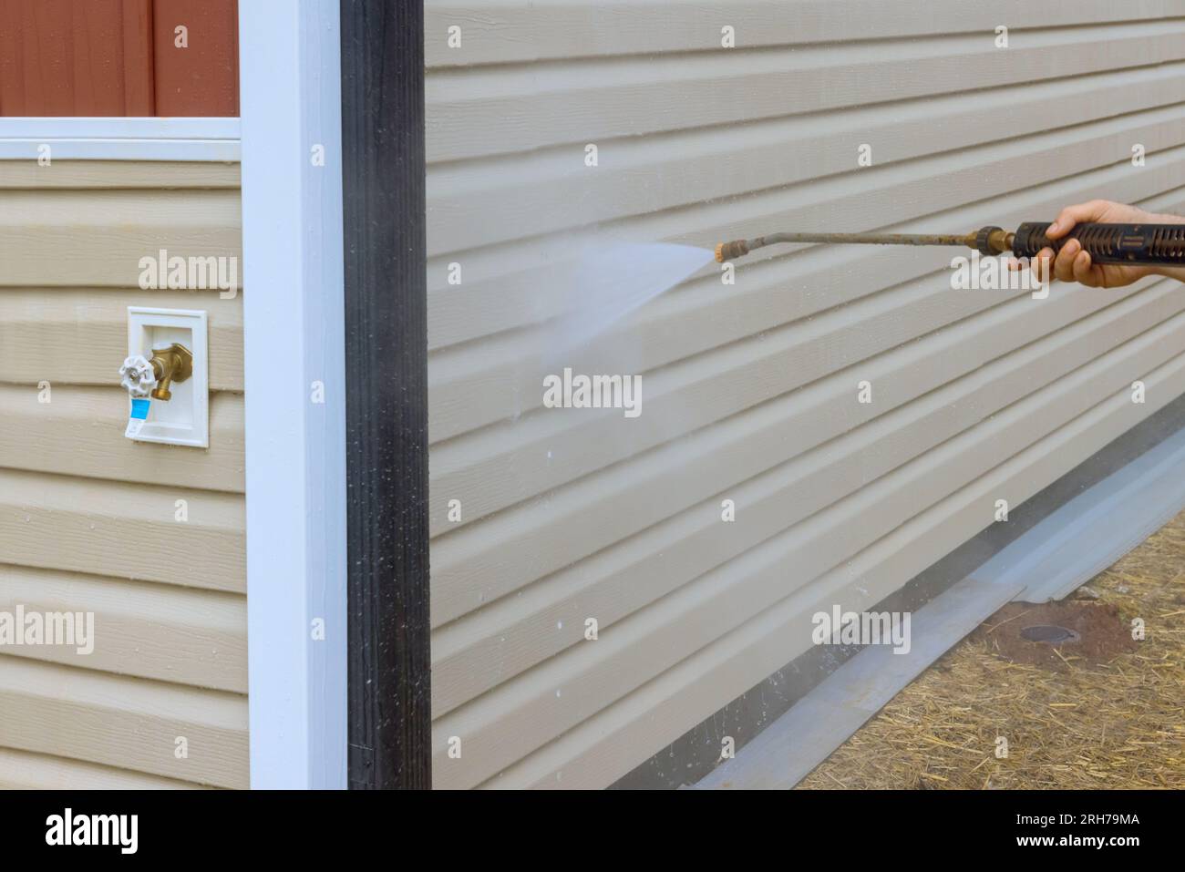 Service worker expertly handles high pressure nozzles to spray water