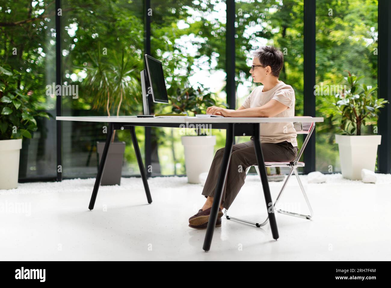 Side view mature woman project manager working at eco-friendly office Stock Photo