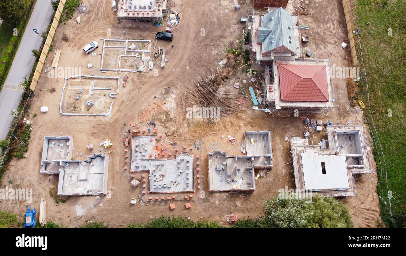 Top down drone aerial shot of quality new homes being built to create a new housing estate. Stock Photo