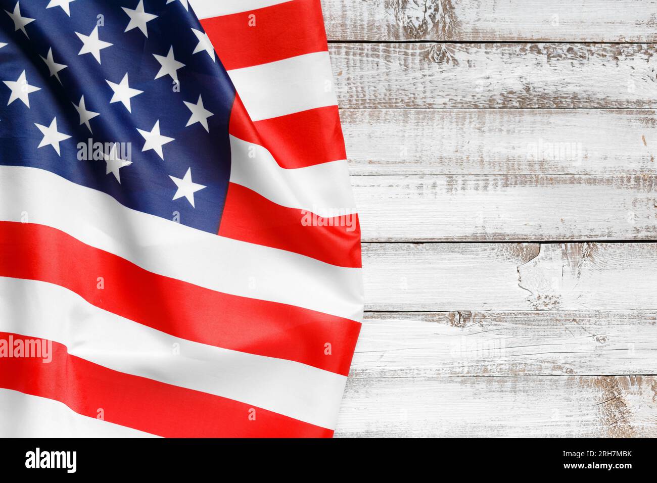 Stars and stripes american flag on rustic wooden background, top view, copy space. The pride of 