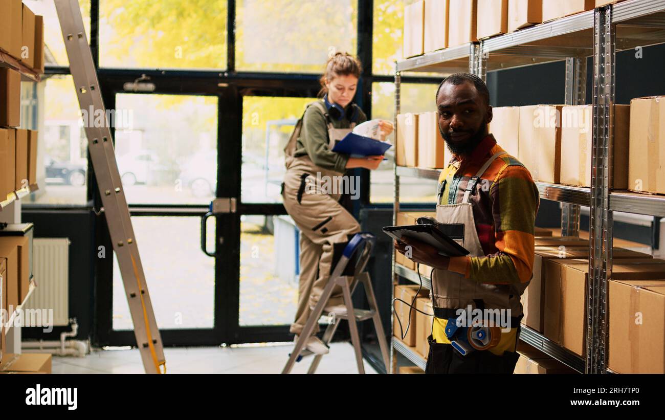Young person scanning barcodes in depot, working on quality control