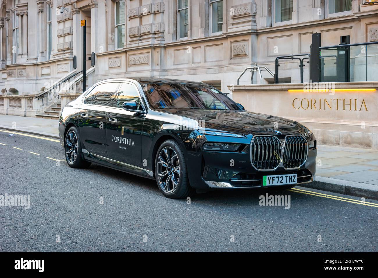 An electric BMW i7 sedan is parked in front of the Corinthia Hotel London in central London England UK. Stock Photo