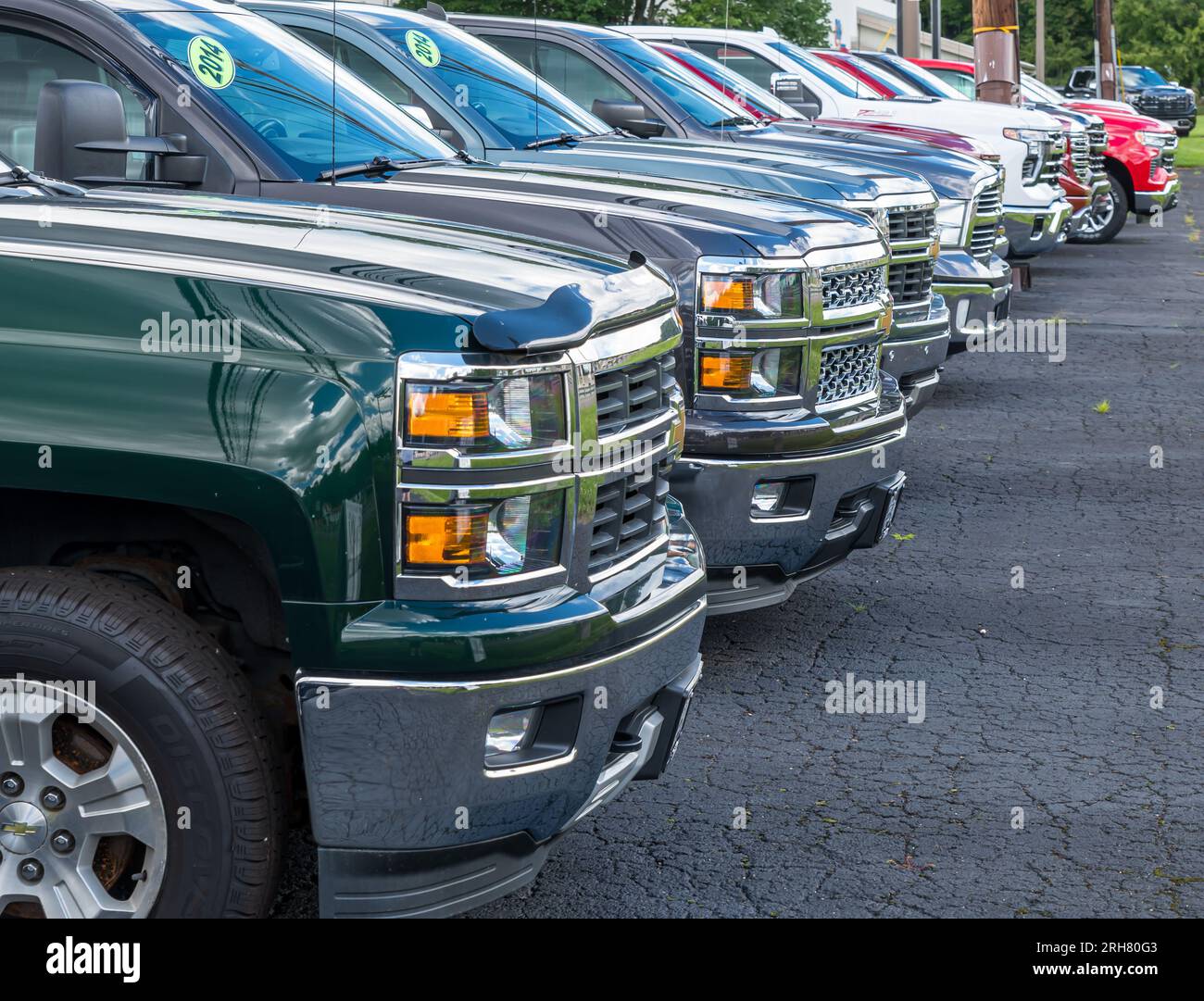 A line of Chevrolet and GMC trucks for sale at a dealership in