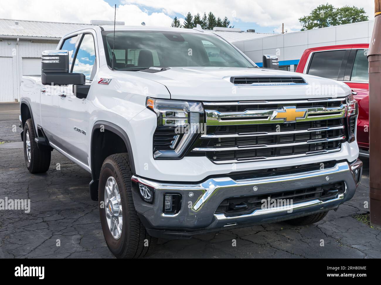 A new, white Chevrolet 2500 HD pickup truck for sale at a dealership in