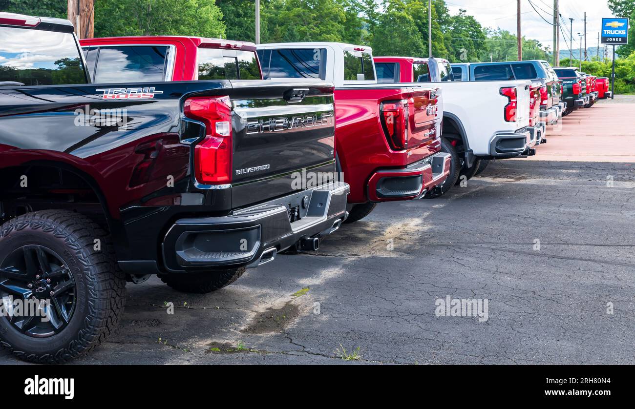 A line of Chevrolet and GMC trucks for sale at a dealership in