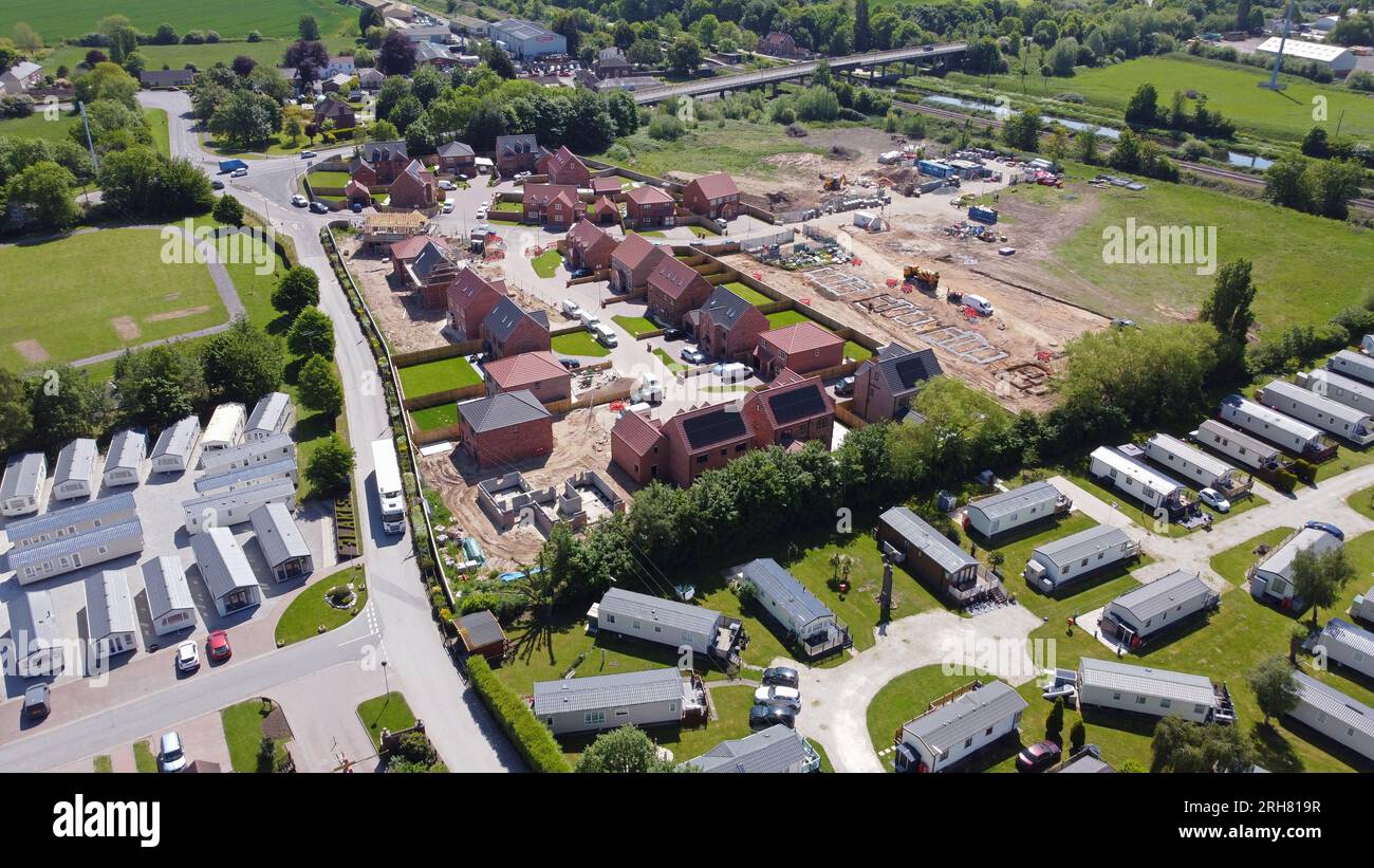 Drone view from the air of a large estate of new build quality homes being built. Stock Photo