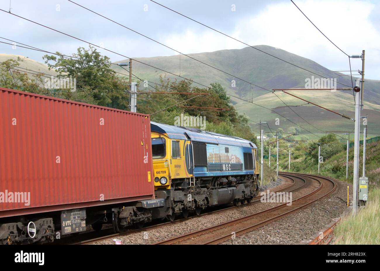 Class 66 shed diesel-electric loco, number 66709 named Sorrento, on container train along West Coast Main Line at Lowgill in Cumbria, 11th August 2023. Stock Photo