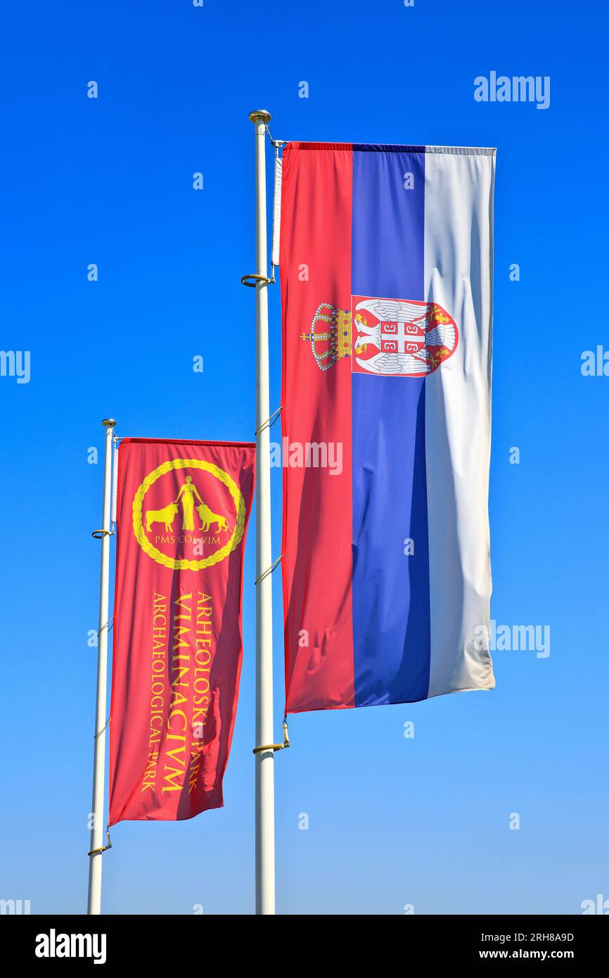The flags of Serbia and Viminacium flying proudly side by side at the archeological park Viminacium in Selo Kostolac, Serbia Stock Photo