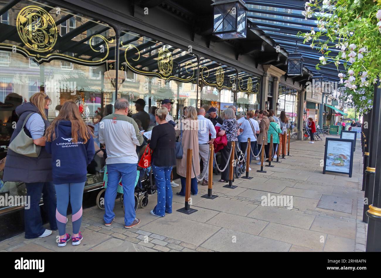 Large queue at the ever popular Bettys Tea Room, Montpellier quarter, 1 Parliament St, Harrogate, North Yorkshire, England, UK,  HG1 2QU Stock Photo