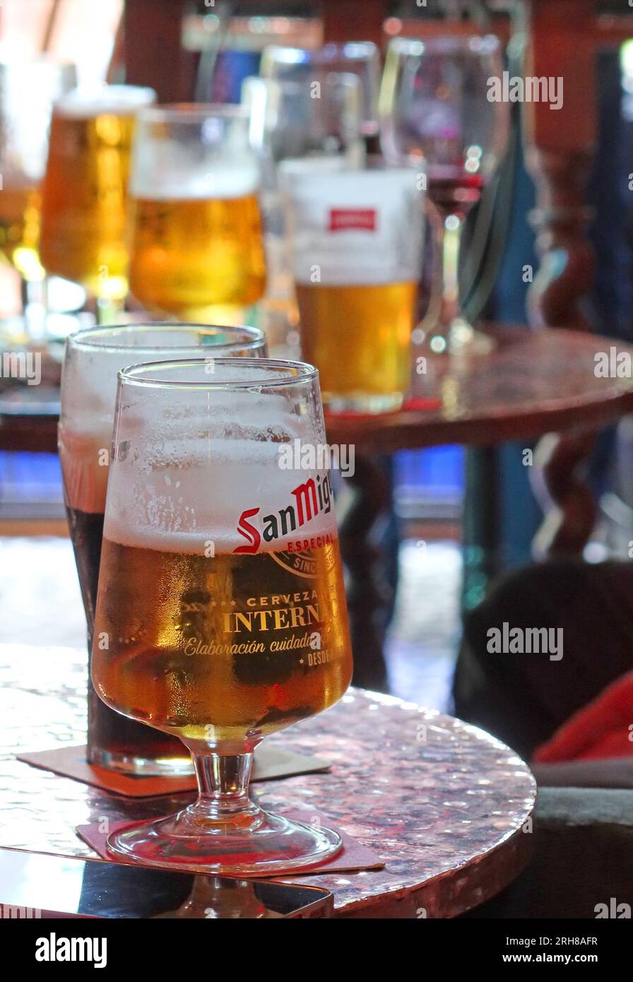 Pub weekend drinking session, half empty pint and wine glasses, British binge drinking Stock Photo