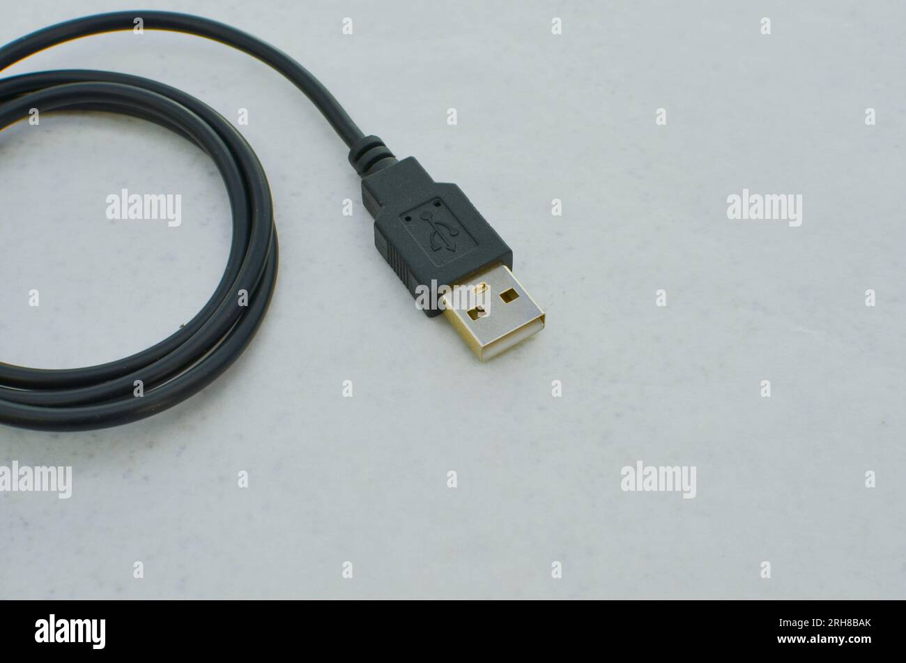 Black USB TypeC cable detail highlighted on a clear surface, perfect