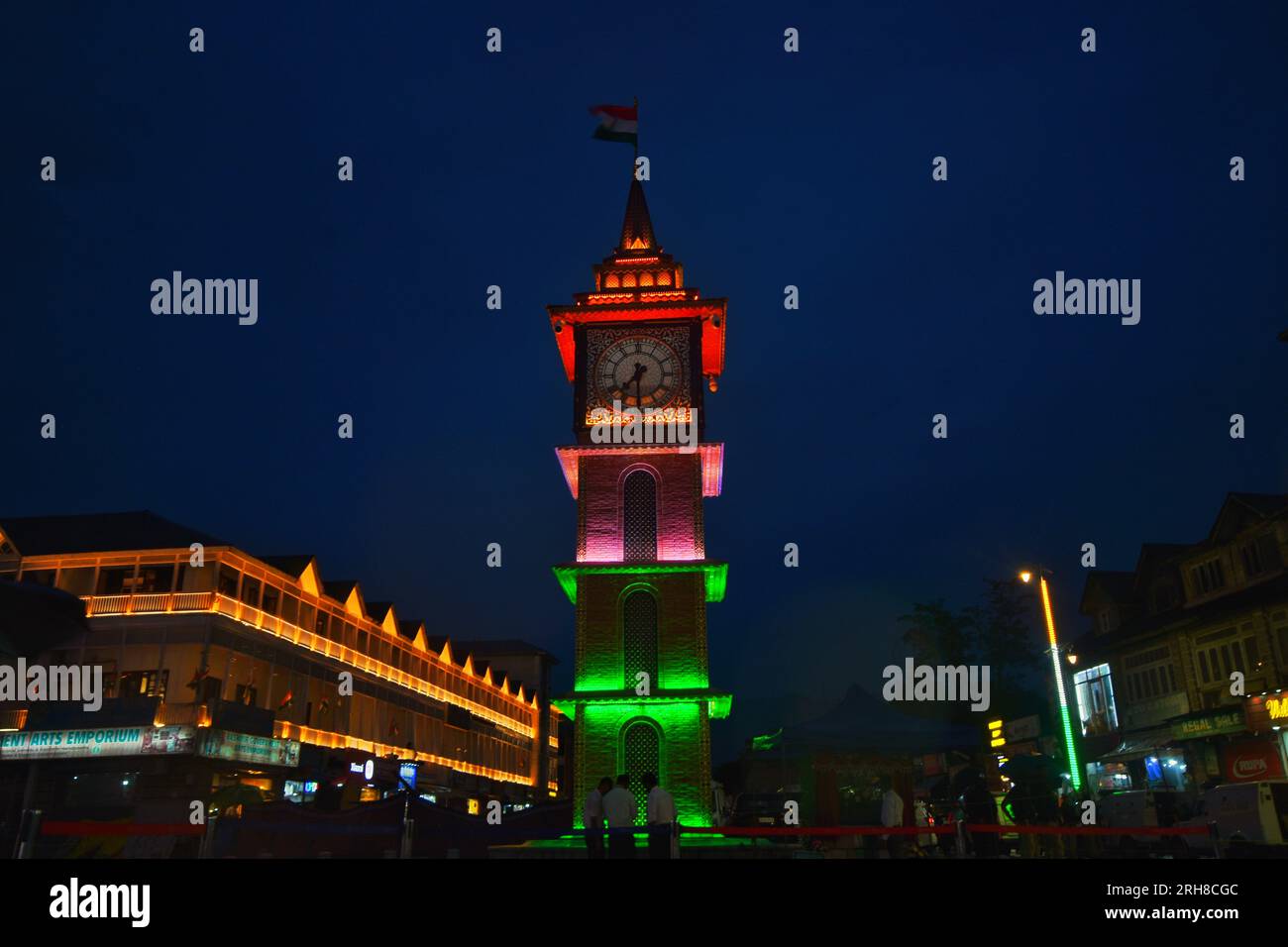 Srinagar, India. 14th Aug, 2023. People walk past the clock tower ...