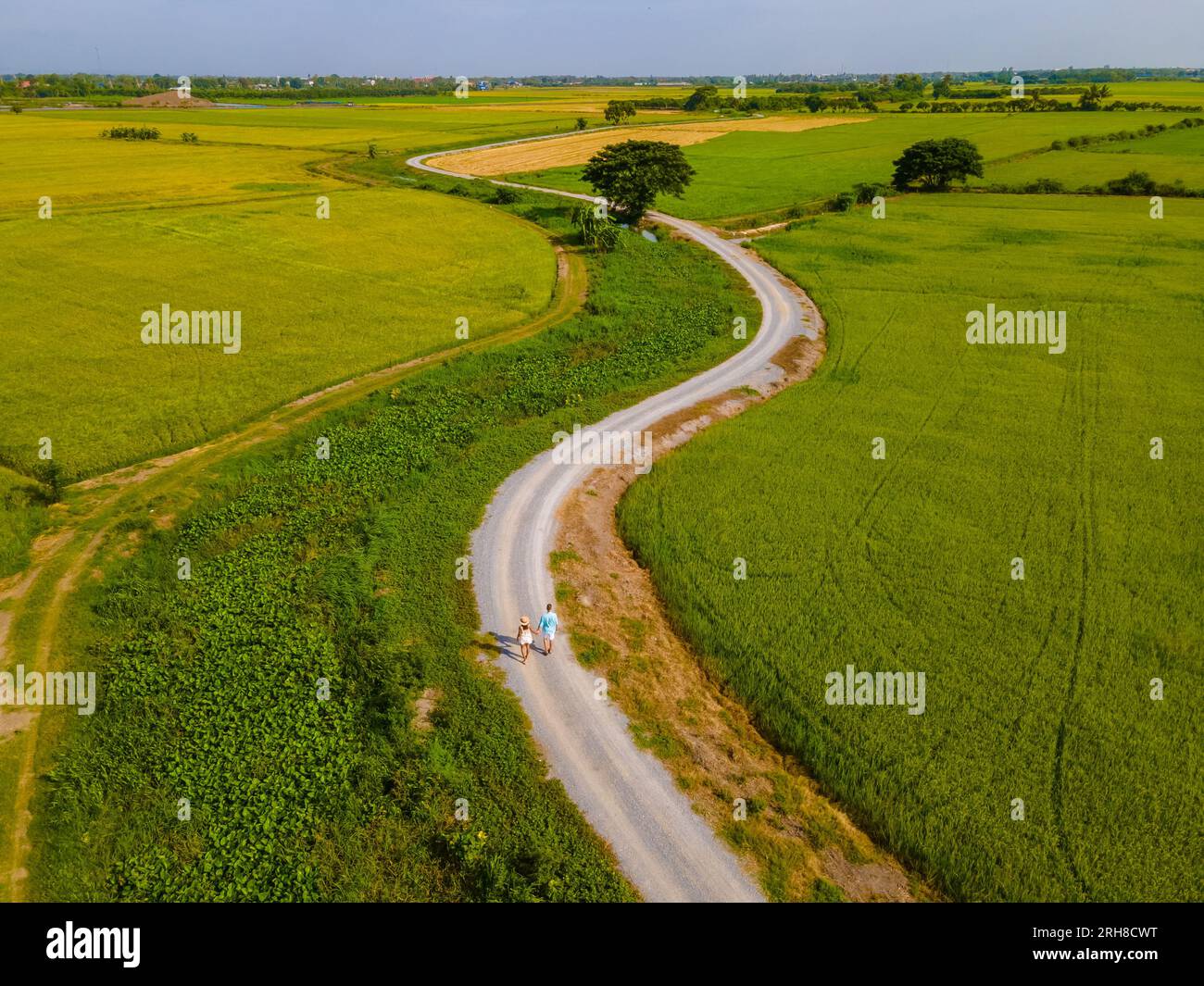 a couple of men and women on vacation in Thailand walking on a curved ...