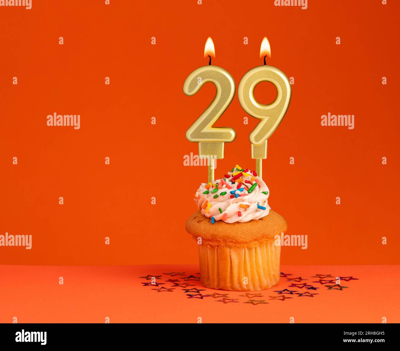 Number 29 candle - Birthday card design in orange background Stock Photo